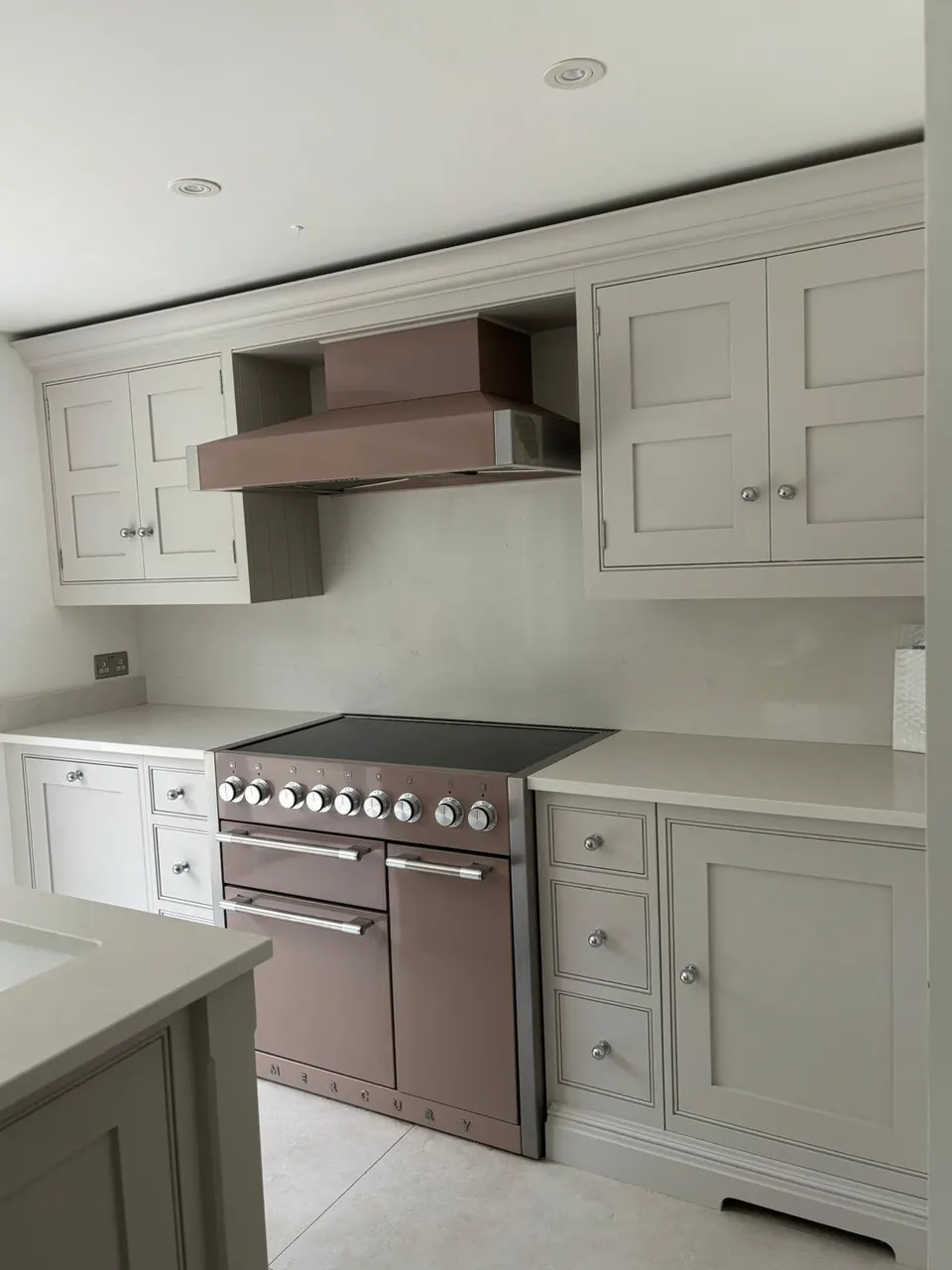 Kitchen with a range cooker and painted cabinets after a deep clean