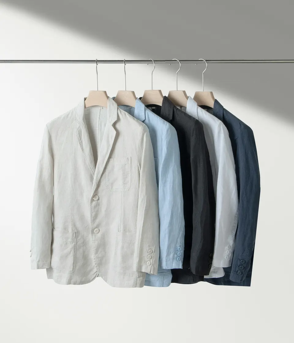 Freshly pressed jackets and shirts hanging on a clothes rail in soft daylight